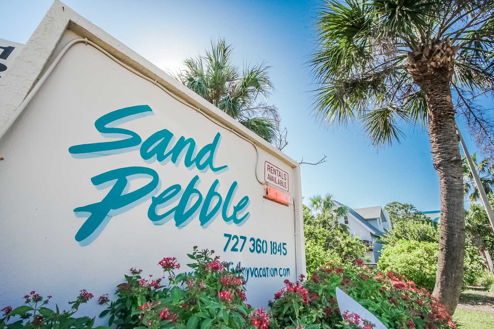 A vibrant resort signage at VRI's Sand Pebble Resort in Treasure Island, Florida.